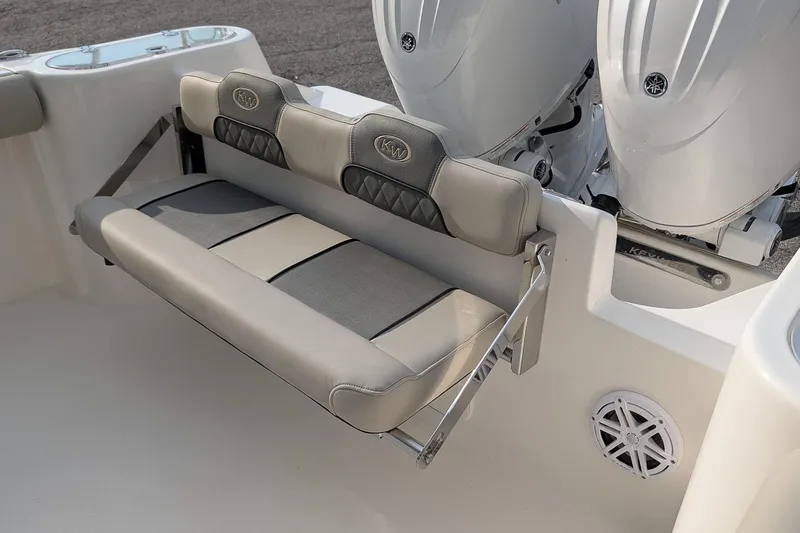 Slide: The Image of 2026 Key West 244 Center Console boat with foldable rear seating and dual engines. - 8