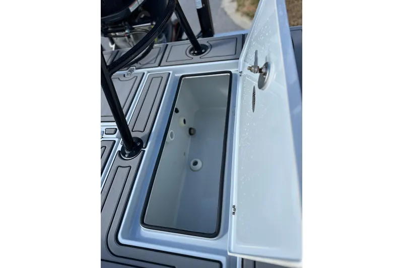 Slide: The Image of 2022 Hewes Redfisher 21 boat storage compartment with open lid, showcasing interior details. - 12