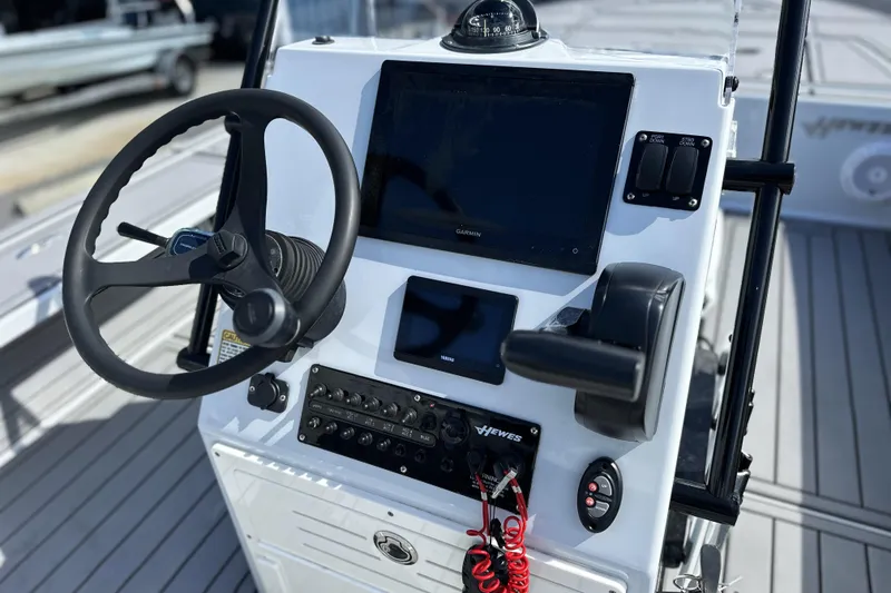 Slide: The Image of 2022 Hewes Redfisher 21 boat console with steering wheel and navigation controls. - 14