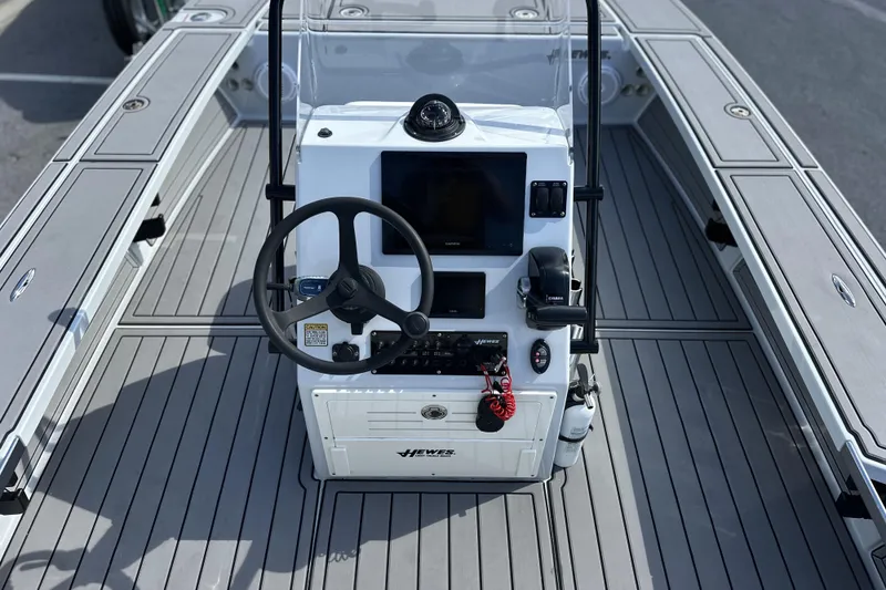 Slide: The Image of 2022 Hewes Redfisher 21 boat console with steering wheel and navigation equipment. - 15