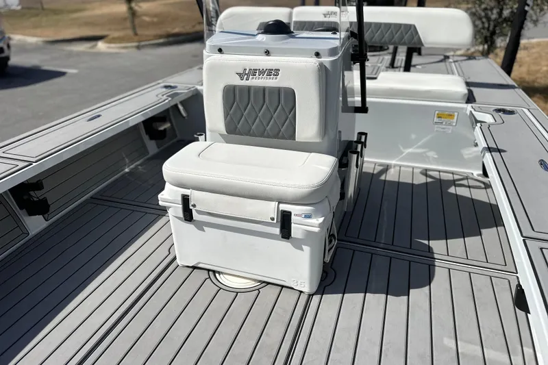 Slide: The Image of 2022 Hewes Redfisher 21 boat interior with cushioned seating and sleek deck design. - 17