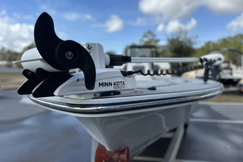 Slide: The Image of 2022 Hewes Redfisher 21 boat with Minn Kota Terrova trolling motor, parked outdoors. - 3
