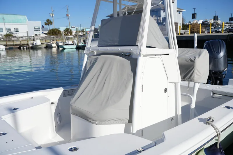 Slide: The Image of 2020 Sea Hunt BX 20 BR boat docked, featuring covered console and seating. - 19