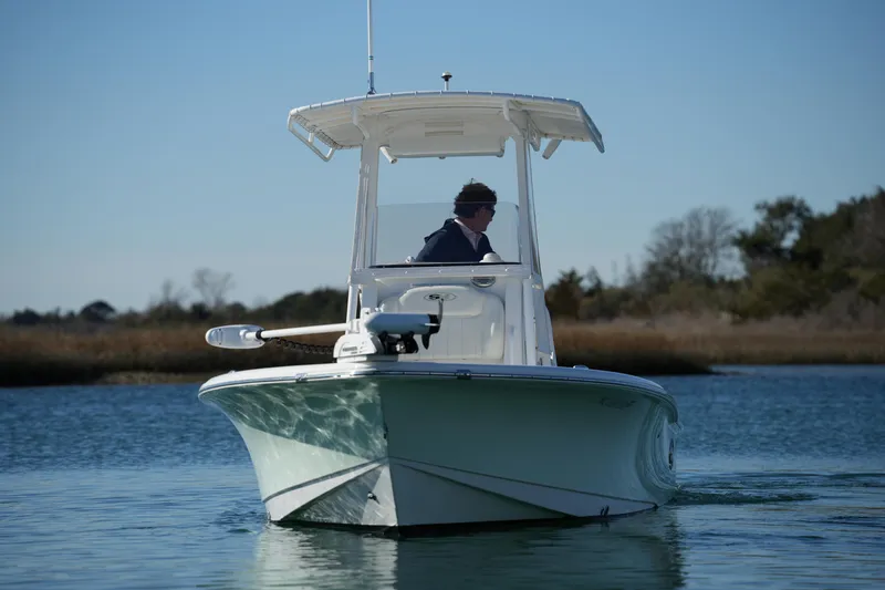 Slide: The Image of 2020 Sea Hunt BX 20 BR boat navigating calm waters under clear sky. - 2