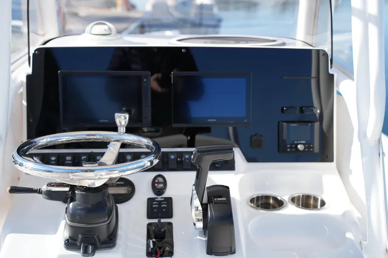 Slide: The Image of 2020 Sea Hunt BX 20 BR boat dashboard with steering wheel and electronic displays. - 26