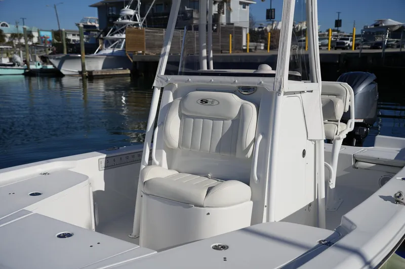 Slide: The Image of 2020 Sea Hunt BX 20 BR boat interior with white seating at marina. - 38