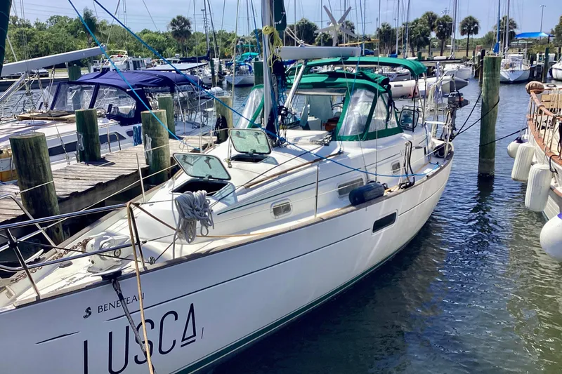 The Image of 1998 Beneteau Oceanis 36 CC sailboat docked near waterfront homes. - 0