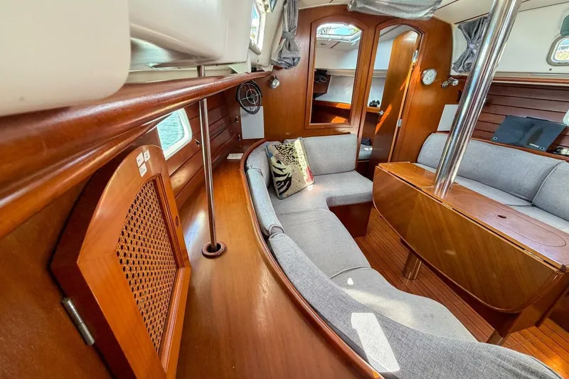 Slide: The Image of Interior of 1998 Beneteau Oceanis 36 CC sailboat with wooden finish and cozy seating. - 10