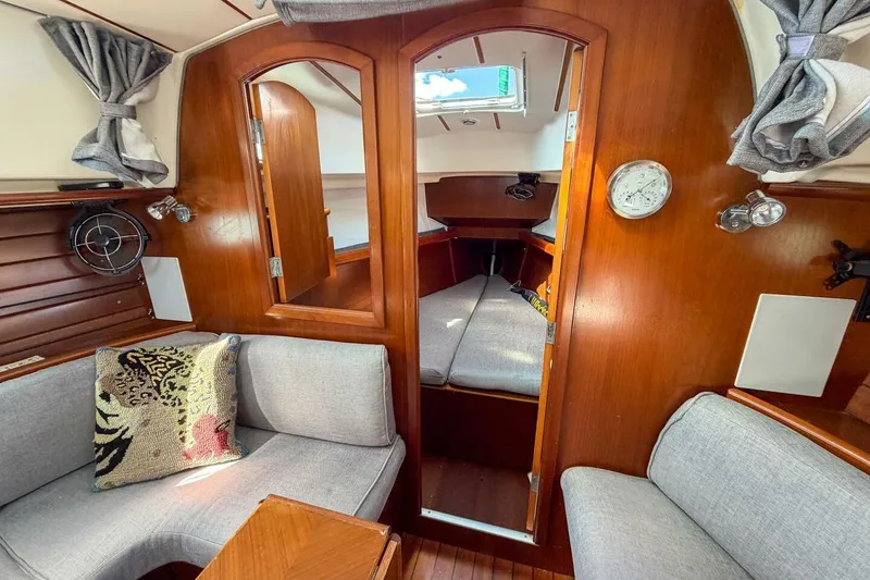 Slide: The Image of Interior of 1998 Beneteau Oceanis 36 CC sailboat with cozy seating and wooden finish. - 12