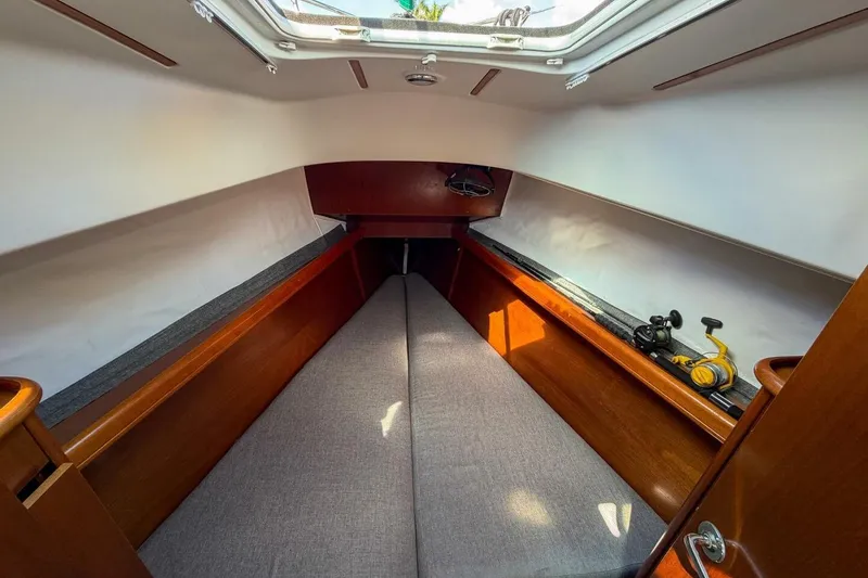 Slide: The Image of Interior cabin of 1998 Beneteau Oceanis 36 CC sailboat, featuring cozy sleeping area. - 13