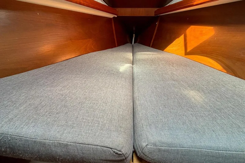 Slide: The Image of Interior cabin view of 1998 Beneteau Oceanis 36 CC sailboat with gray cushions. - 14