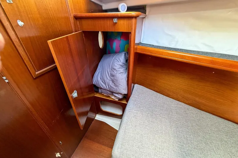 Slide: The Image of Cozy cabin interior of 1998 Beneteau Oceanis 36 CC sailboat with wooden storage and bedding. - 16
