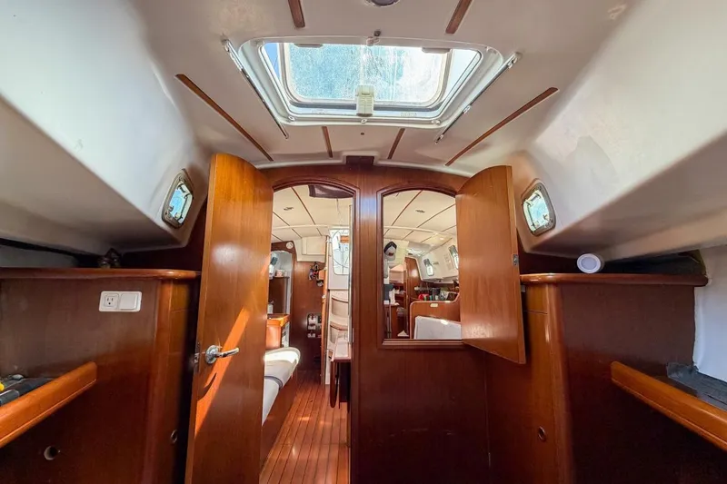 Slide: The Image of Interior of 1998 Beneteau Oceanis 36 CC sailboat, featuring wood paneling and skylight. - 17