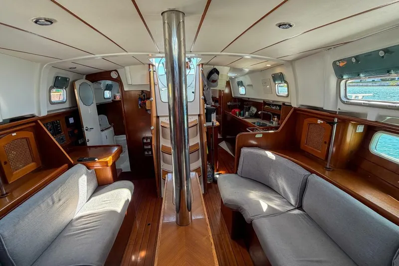 Slide: The Image of Interior of 1998 Beneteau Oceanis 36 CC sailboat with cozy seating and wooden finishes. - 18