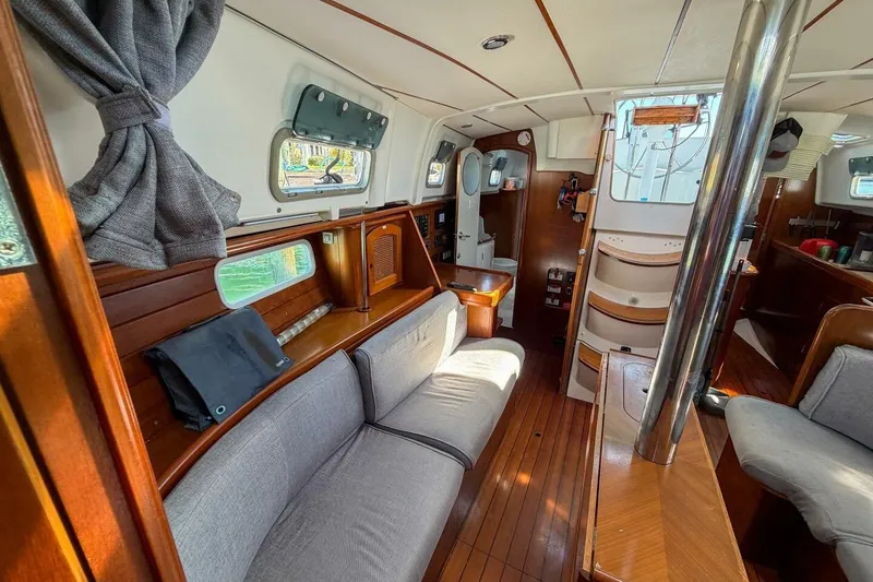 Slide: The Image of Interior of 1998 Beneteau Oceanis 36 CC sailboat with cozy seating and wooden finishes. - 19