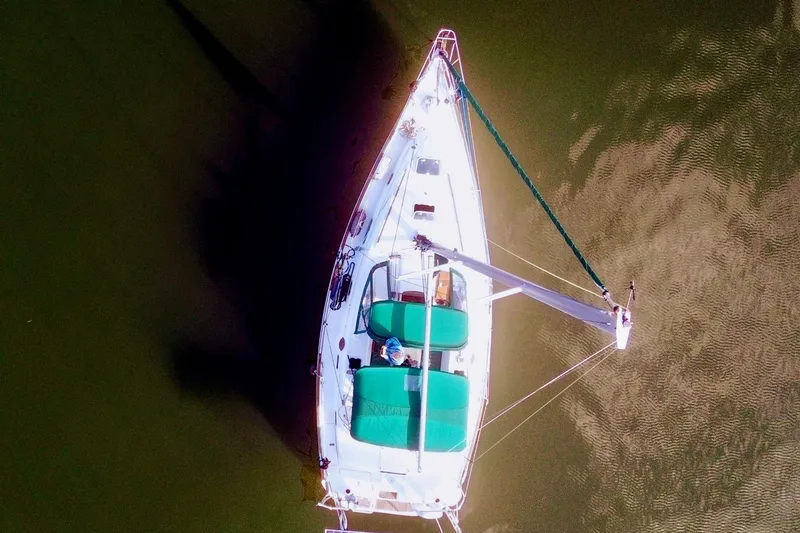 Slide: The Image of Interior of 1998 Beneteau Oceanis 36 CC sailboat with cozy seating and wooden finishes. - 2