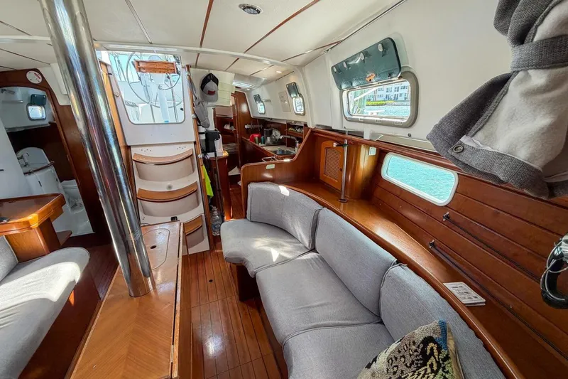 Slide: The Image of Interior of 1998 Beneteau Oceanis 36 CC sailboat, featuring cozy seating and wooden finishes. - 20