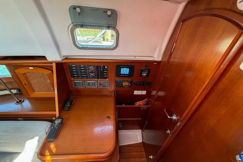 Slide: The Image of 1998 Beneteau Oceanis 36 CC interior with navigation panel and wooden cabinetry. - 22