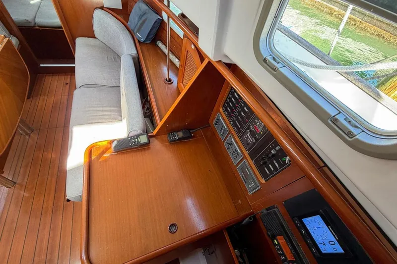 Slide: The Image of Interior of 1998 Beneteau Oceanis 36 CC sailboat with navigation equipment and wooden finish. - 23