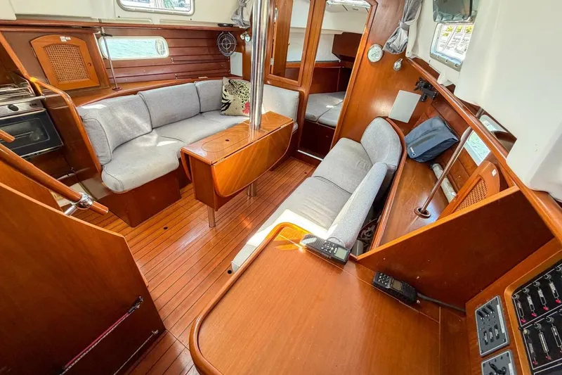 Slide: The Image of Interior of 1998 Beneteau Oceanis 36 CC sailboat with wooden finish and cozy seating. - 24