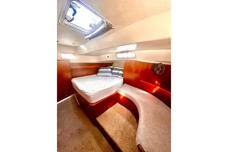 Slide: The Image of Interior of 1998 Beneteau Oceanis 36 CC sailboat with cozy seating and wooden finishes. - 3