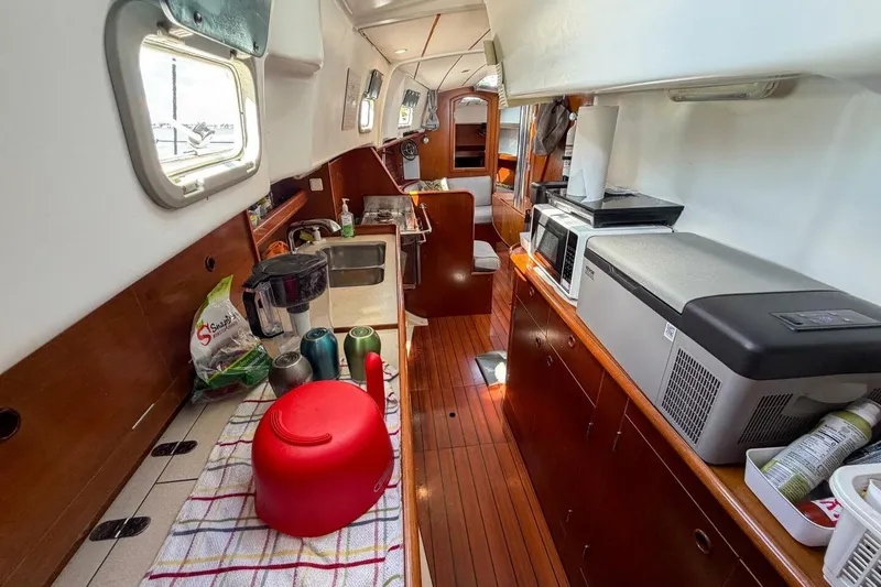 Slide: The Image of Interior of 1998 Beneteau Oceanis 36 CC sailboat, featuring a well-equipped galley kitchen. - 32
