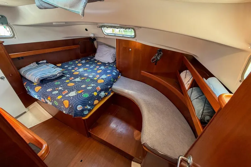 Slide: The Image of Cozy cabin interior of 1998 Beneteau Oceanis 36 CC sailboat with colorful bedding. - 36