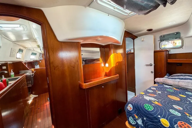 Slide: The Image of Interior of 1998 Beneteau Oceanis 36 CC sailboat with cozy cabin and wooden finishes. - 37