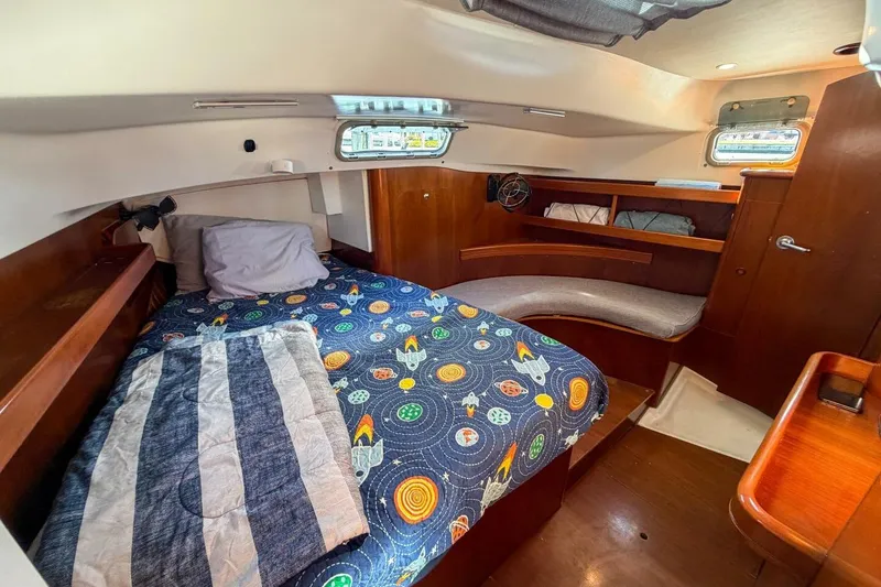 Slide: The Image of Cozy cabin interior of 1998 Beneteau Oceanis 36 CC sailboat with colorful bedding. - 38