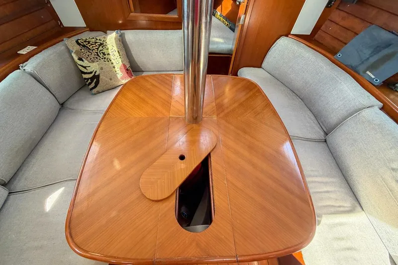 Slide: The Image of Interior of 1998 Beneteau Oceanis 36 CC sailboat with wooden table and cushioned seating. - 4