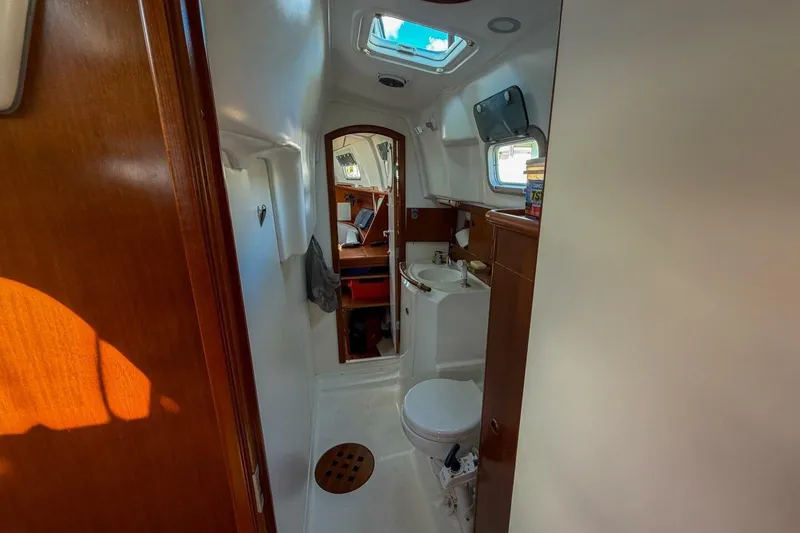 Slide: The Image of Interior of 1998 Beneteau Oceanis 36 CC yacht bathroom with wooden accents and skylight. - 40