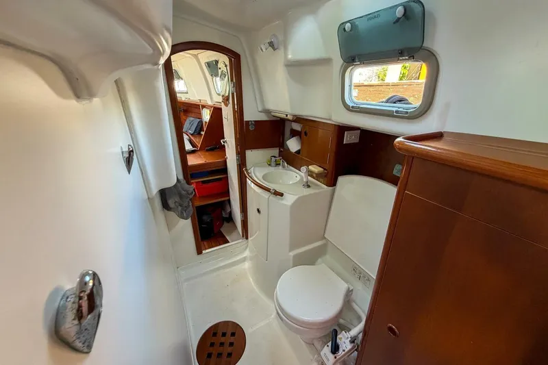 Slide: The Image of Bathroom interior of 1998 Beneteau Oceanis 36 CC yacht, featuring sink and toilet. - 41