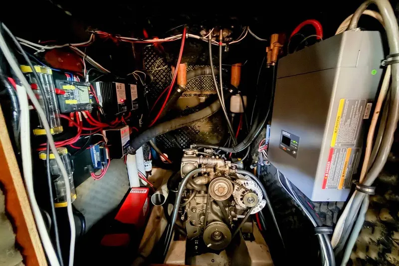 Slide: The Image of Engine room of 1998 Beneteau Oceanis 36 CC sailboat, showcasing wiring and machinery. - 43