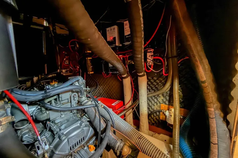 Slide: The Image of Engine room of 1998 Beneteau Oceanis 36 CC sailboat with visible wiring and components. - 46