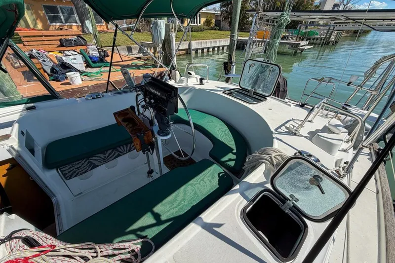 Slide: The Image of 1998 Beneteau Oceanis 36 CC sailboat cockpit with green seating and open hatches. - 49
