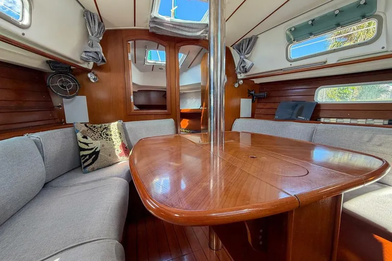 Slide: The Image of Interior of 1998 Beneteau Oceanis 36 CC sailboat with wooden table and gray seating. - 5