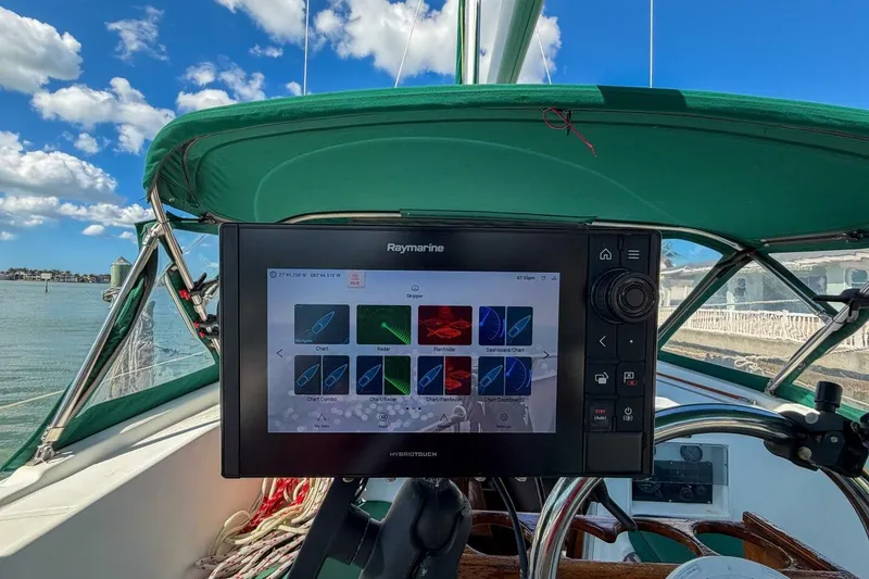 Slide: The Image of Cockpit of 1998 Beneteau Oceanis 36 CC with Raymarine navigation system, under clear blue sky. - 53