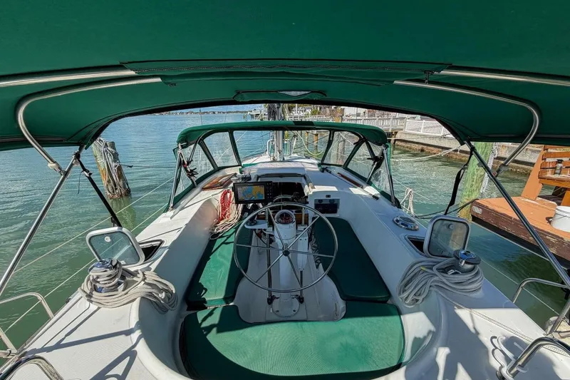 Slide: The Image of 1998 Beneteau Oceanis 36 CC sailboat cockpit with green canopy and steering wheel. - 57