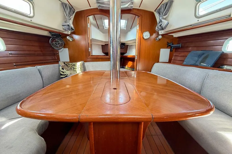 Slide: The Image of Interior of 1998 Beneteau Oceanis 36 CC sailboat with wooden table and seating. - 6