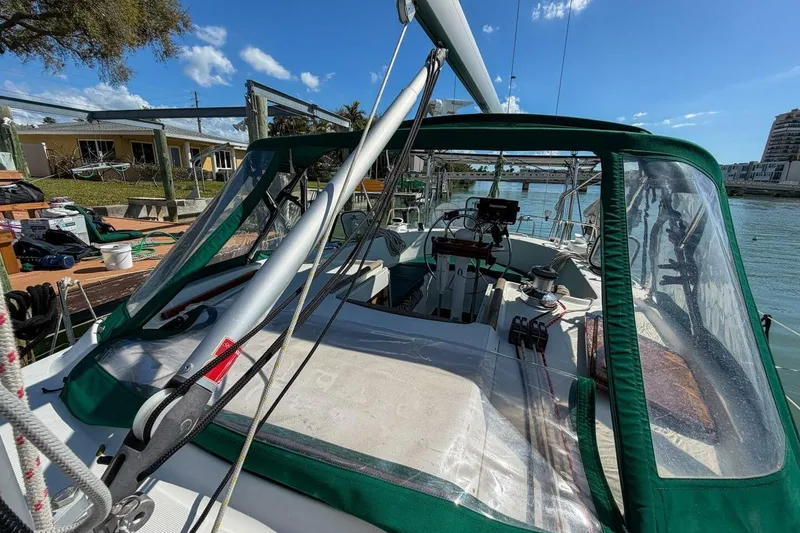 Slide: The Image of 1998 Beneteau Oceanis 36 CC sailboat docked, featuring green canopy and clear windows. - 69