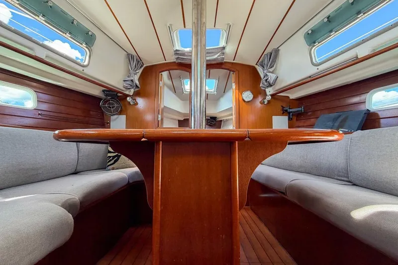 Slide: The Image of Interior of 1998 Beneteau Oceanis 36 CC sailboat with wooden table and seating. - 7