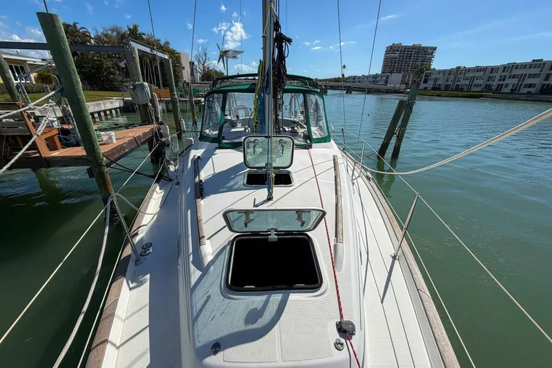 Slide: The Image of 1998 Beneteau Oceanis 36 CC sailboat docked in a sunny marina. - 73
