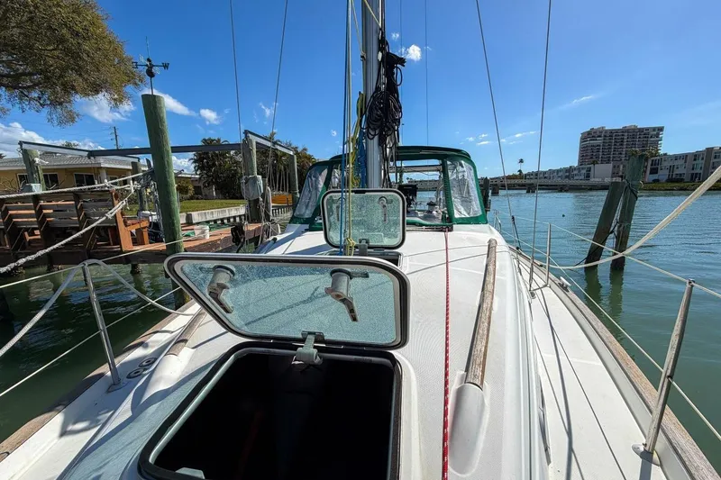 Slide: The Image of 1998 Beneteau Oceanis 36 CC sailboat docked, open hatch, sunny marina view. - 74