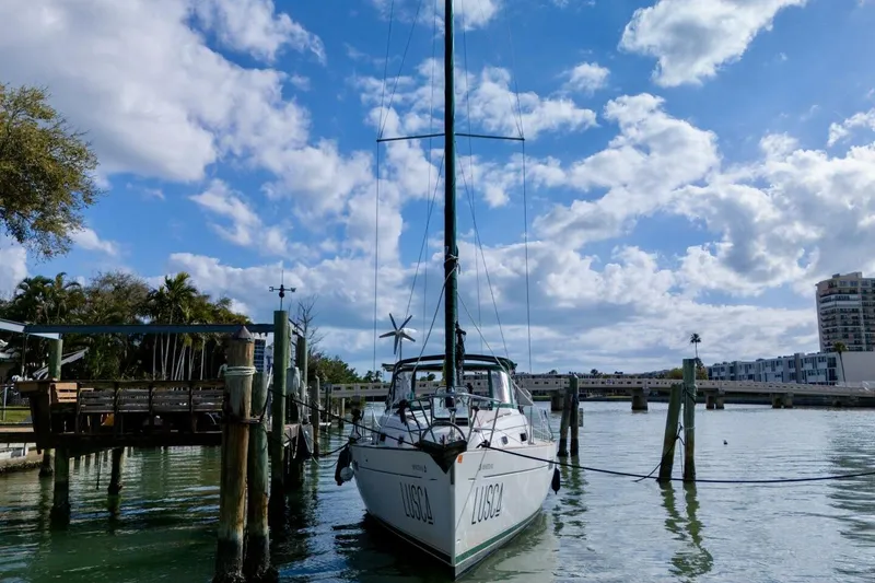 Slide: The Image of 1998 Beneteau Oceanis 36 CC sailboat docked under a partly cloudy sky. - 75