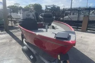 Slide: The Image of 2026 Lund 1650 Angler SS boat in red, parked outdoors on a trailer. - 3