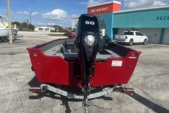 Slide: The Image of 2026 Lund 1650 Angler SS boat with 50 HP motor, parked outdoors. - 6