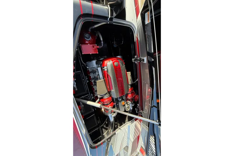Slide: The Image of Engine compartment of 2018 MTI 43 R/P boat, featuring a powerful red engine. - 12