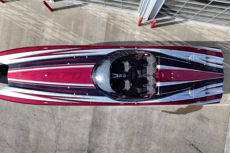 Slide: The Image of Overhead view of a 2018 MTI 43 R/P powerboat with sleek red and black design. - 2