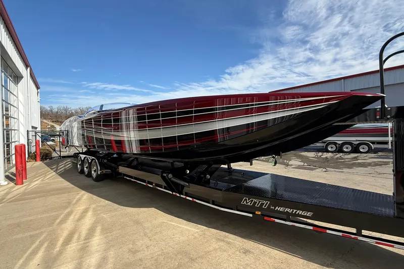 Slide: The Image of 2018 MTI 43 R/P powerboat on trailer, sleek design, vibrant colors, clear sky background. - 7