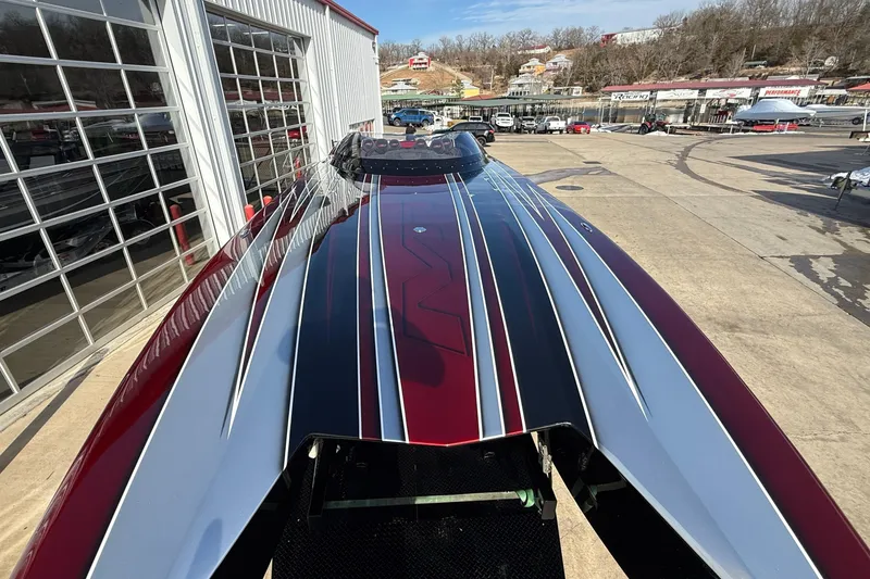 Slide: The Image of 2018 MTI 43 R/P powerboat with sleek red and black design at a marina. - 8